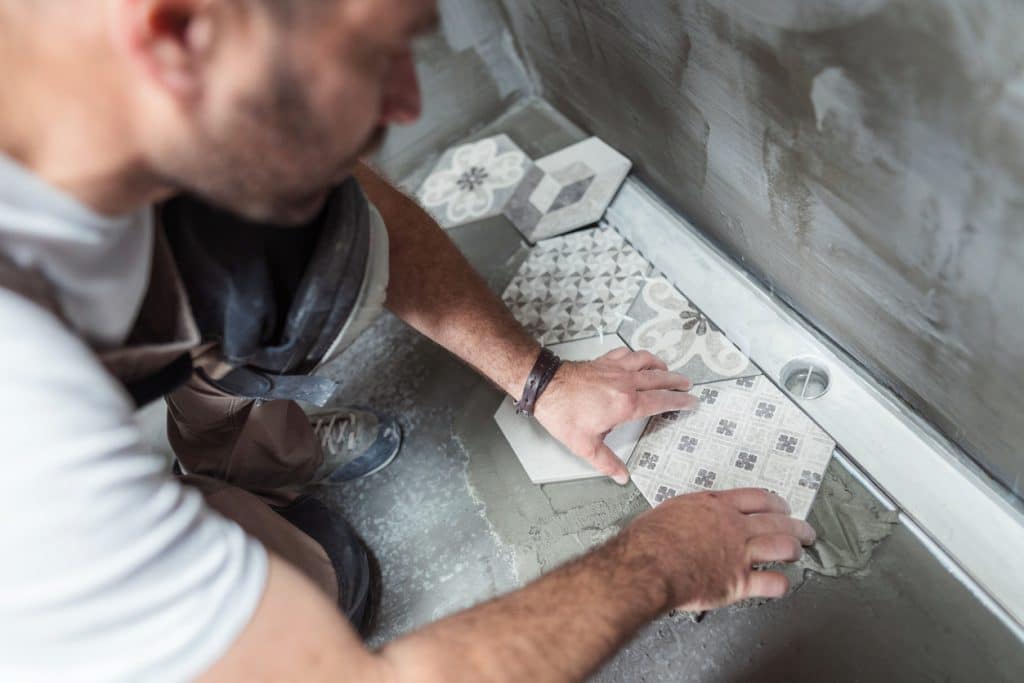 Tiler installing tiles on the bathroom floor